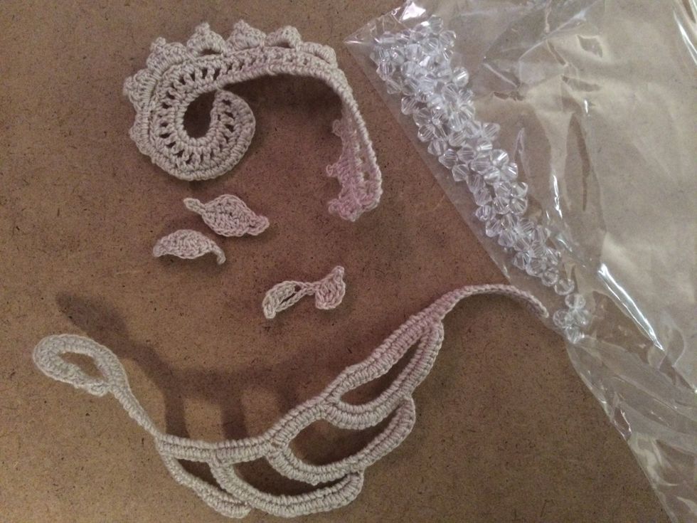 Choose your embellishments. Here, you can see I've chosen some Irish lace crochet motifs I've been working on and a few reflective beads.