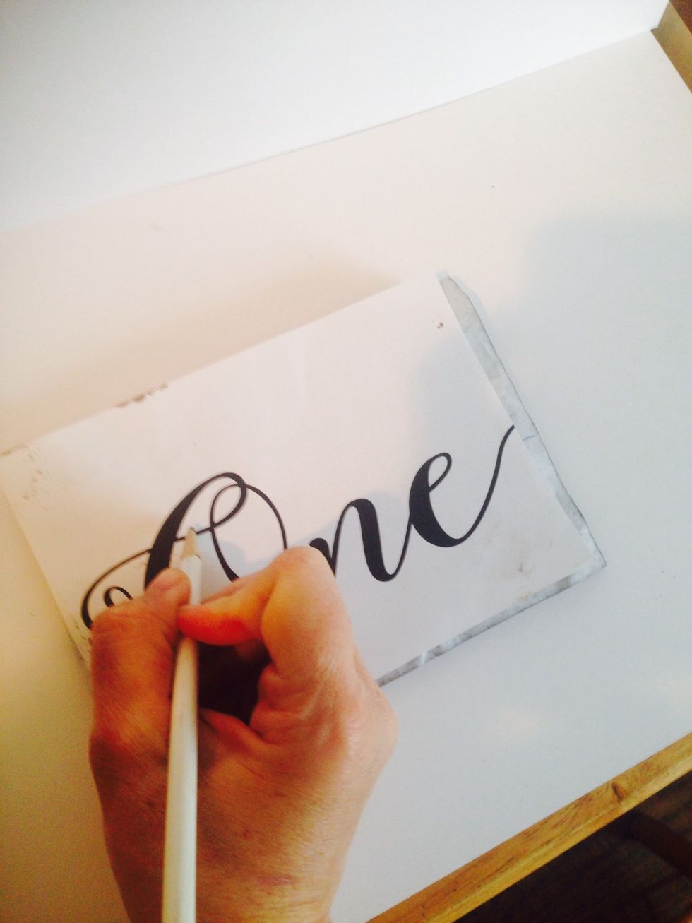 Choose your favorite cursive font and Print out table numbers onto computer paper. Lay your graphite paper face down and the print out on top. Trace each table number.