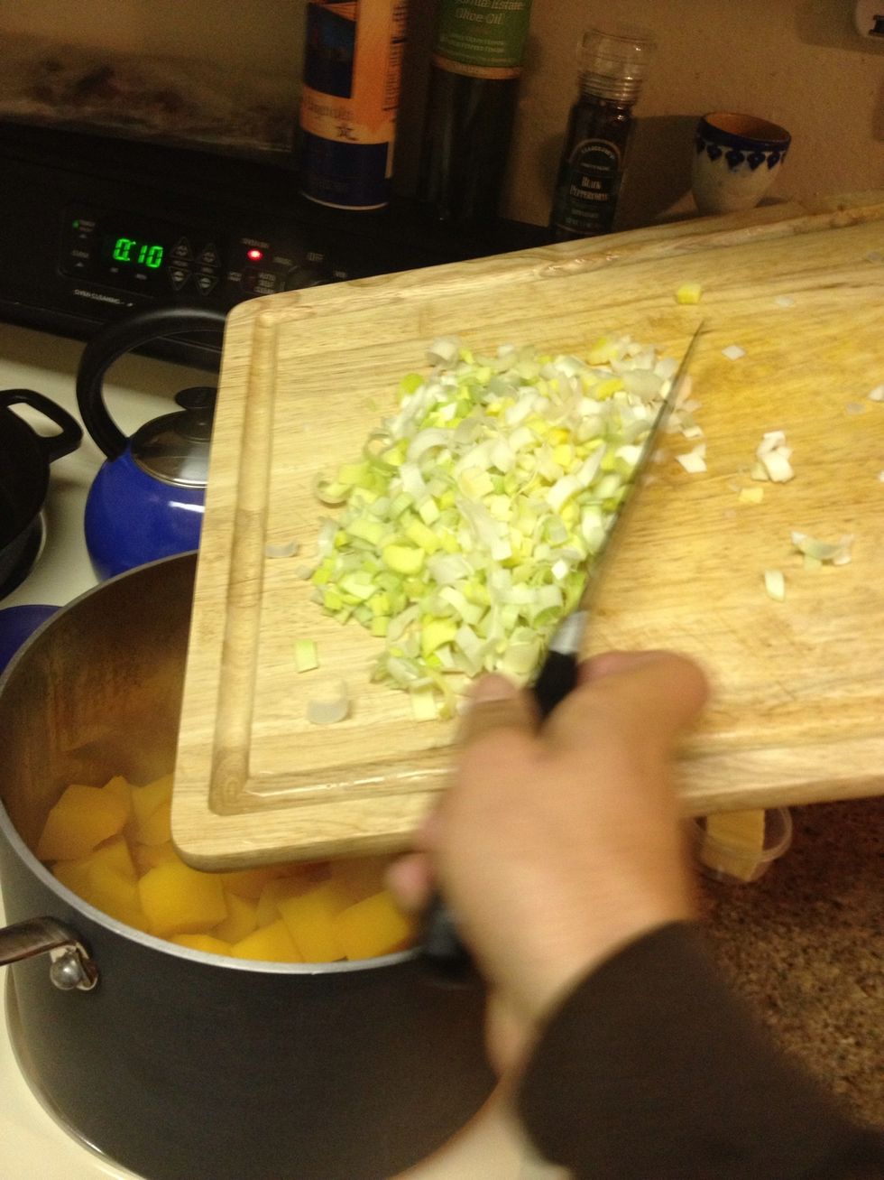 Chop 2 leeks white and green parts only. Add to pot with squash and 2 tablespoons butter.