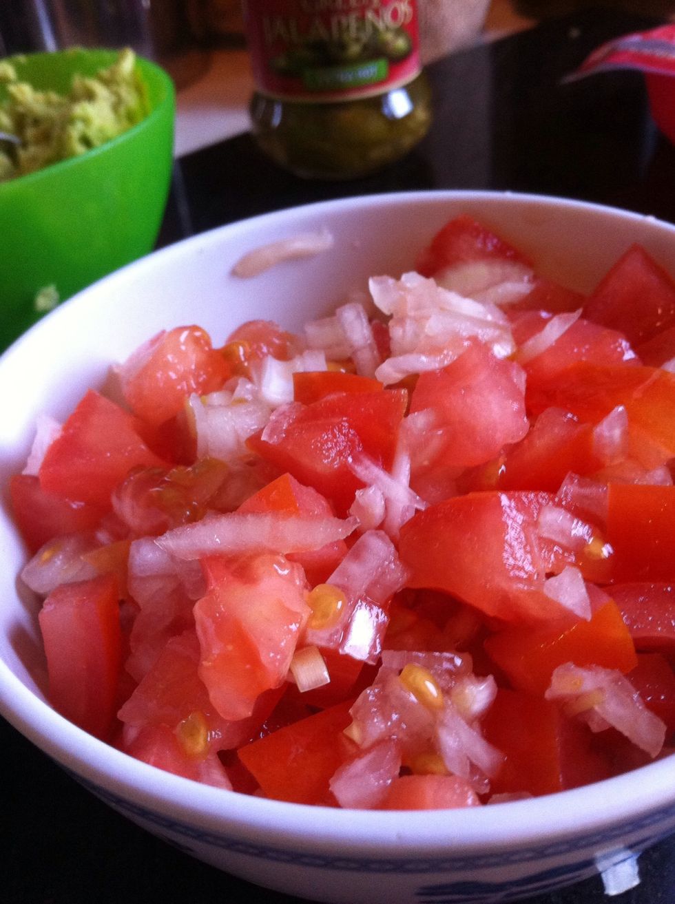 Chop 2 small oinons, preferably red not white like mine, 3 tomatoes and then sprinkle some salt pepper and lemon juice on it.