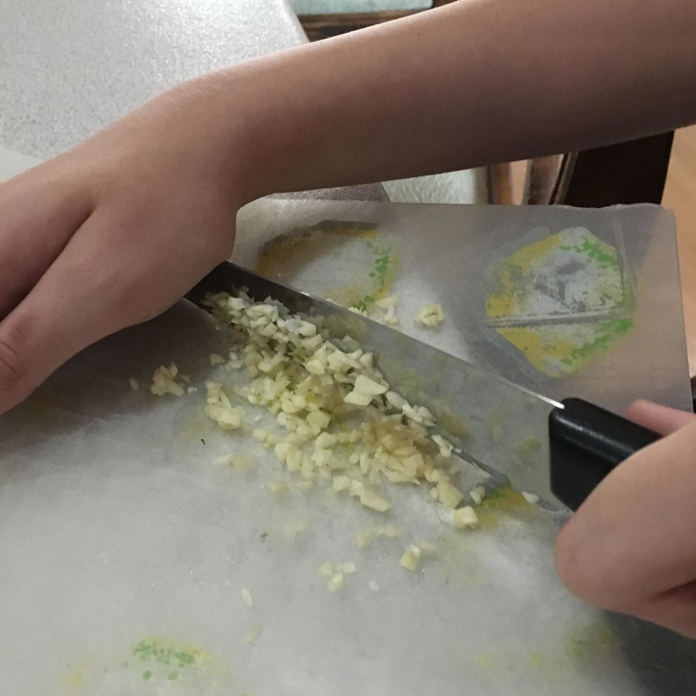 Chop 6 cloves of garlic. You will only be using 3 for the sauce, save the rest for the vegetables.