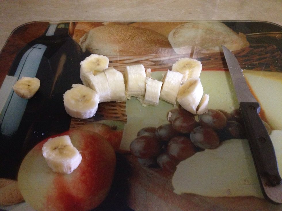 Chop a banana and cut out any nasty bits. Place it into a milk shaker cup