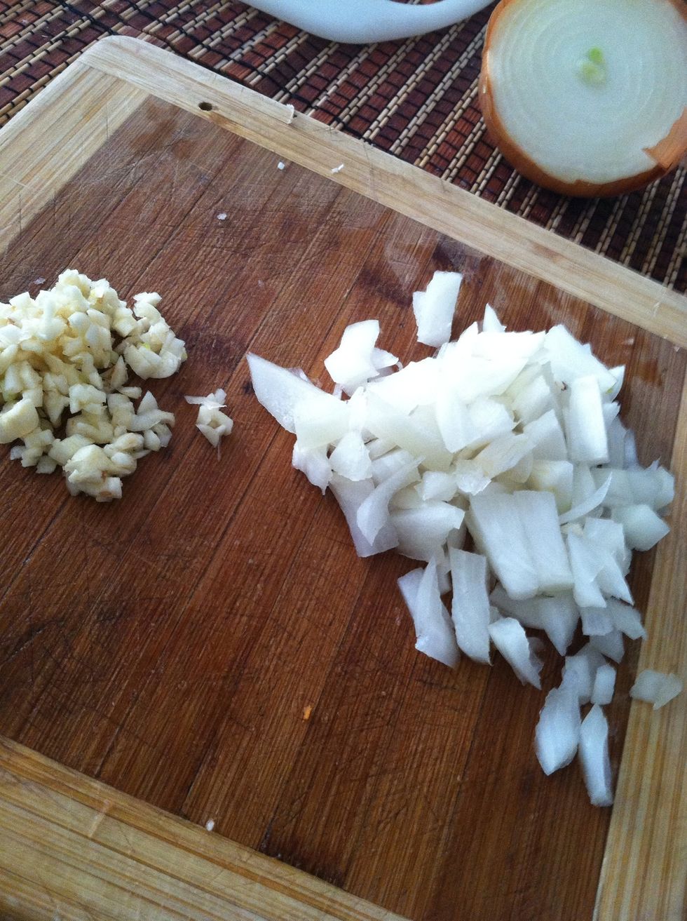 Chop a half of an onion and about a tbs of garlic... Then add to a pan on med-high heat..