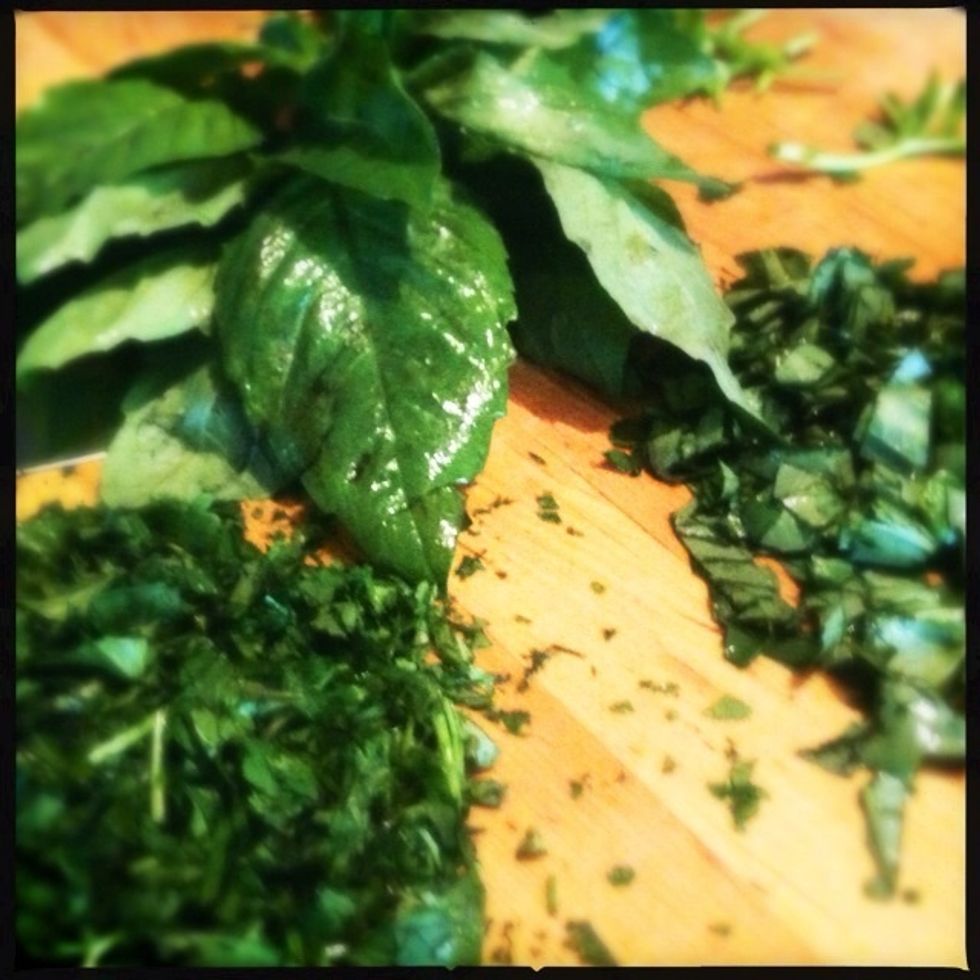 Chop basil and cilantro and set aside to garnish the soup after it is cooked.