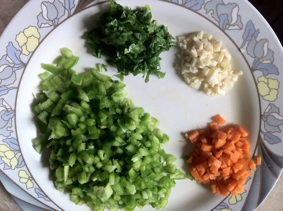 Chop bell pepper, carrot, garlic and parsley into very tiny small pieces.