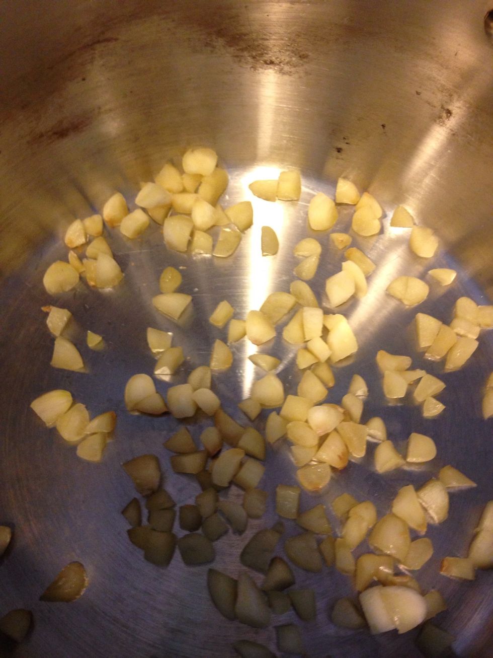 Chop garlic, and place in a large pot! Saut\u00e9 with onions, and oil.