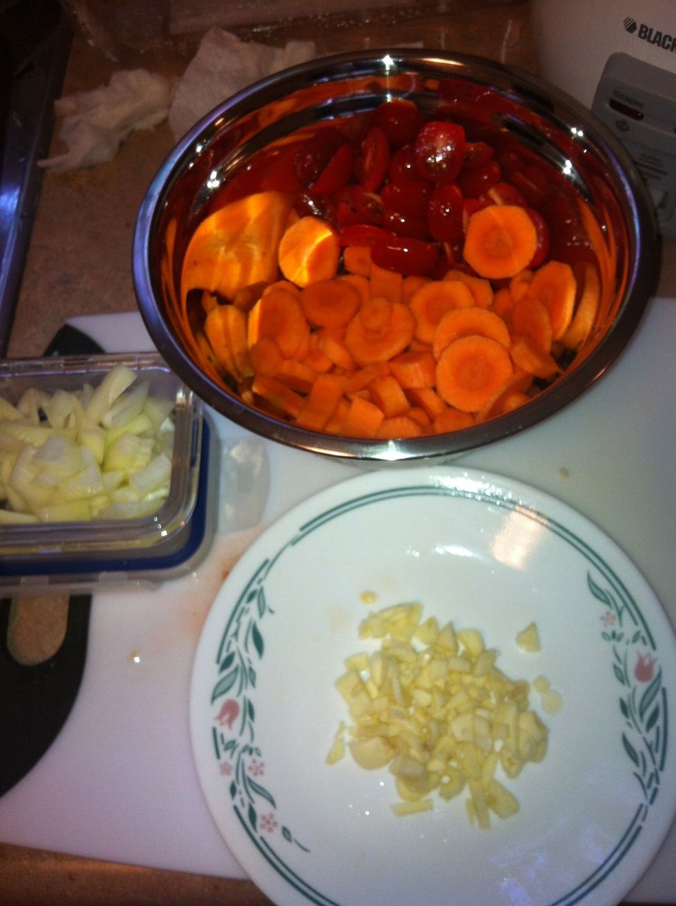 Chop garlic, onion, carrots and grape tomatoes into small pieces