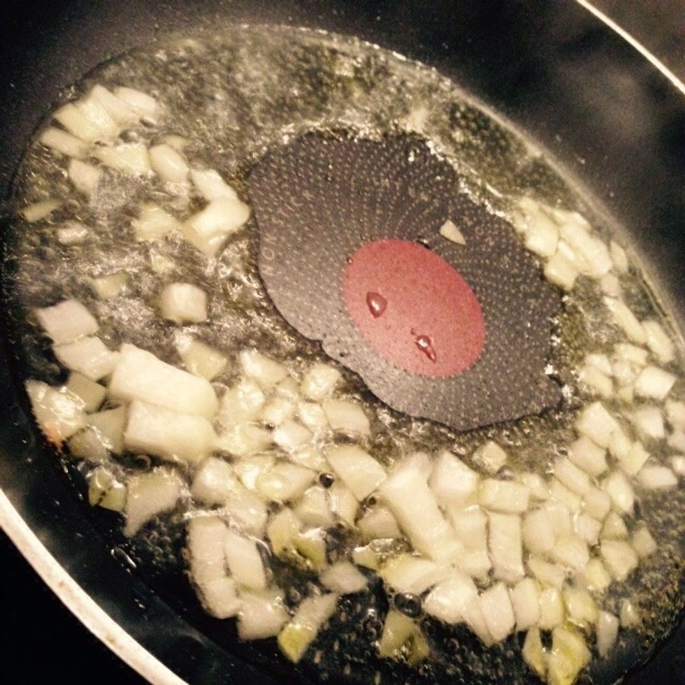 Chop half of the onion and add it to a pan with some olive oil and a splash of water