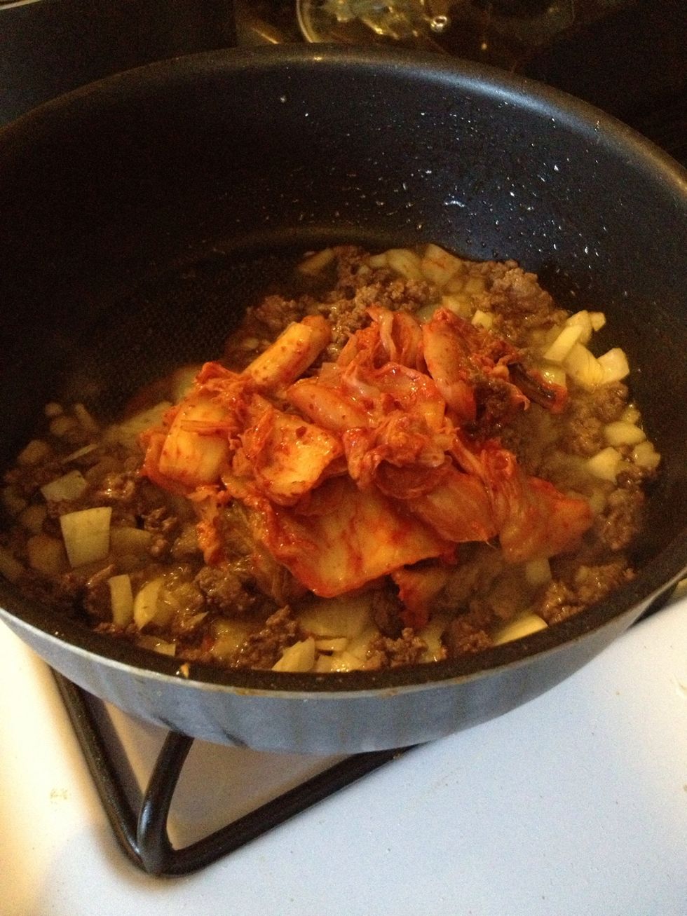 Chop kimchi into small pieces. Saut\u00e9 the meat (or other substitutes) with vegetable or olive oil in frying pan. When the meat is cooked, add chopped onions, kimchi and cook for 5 minutes.