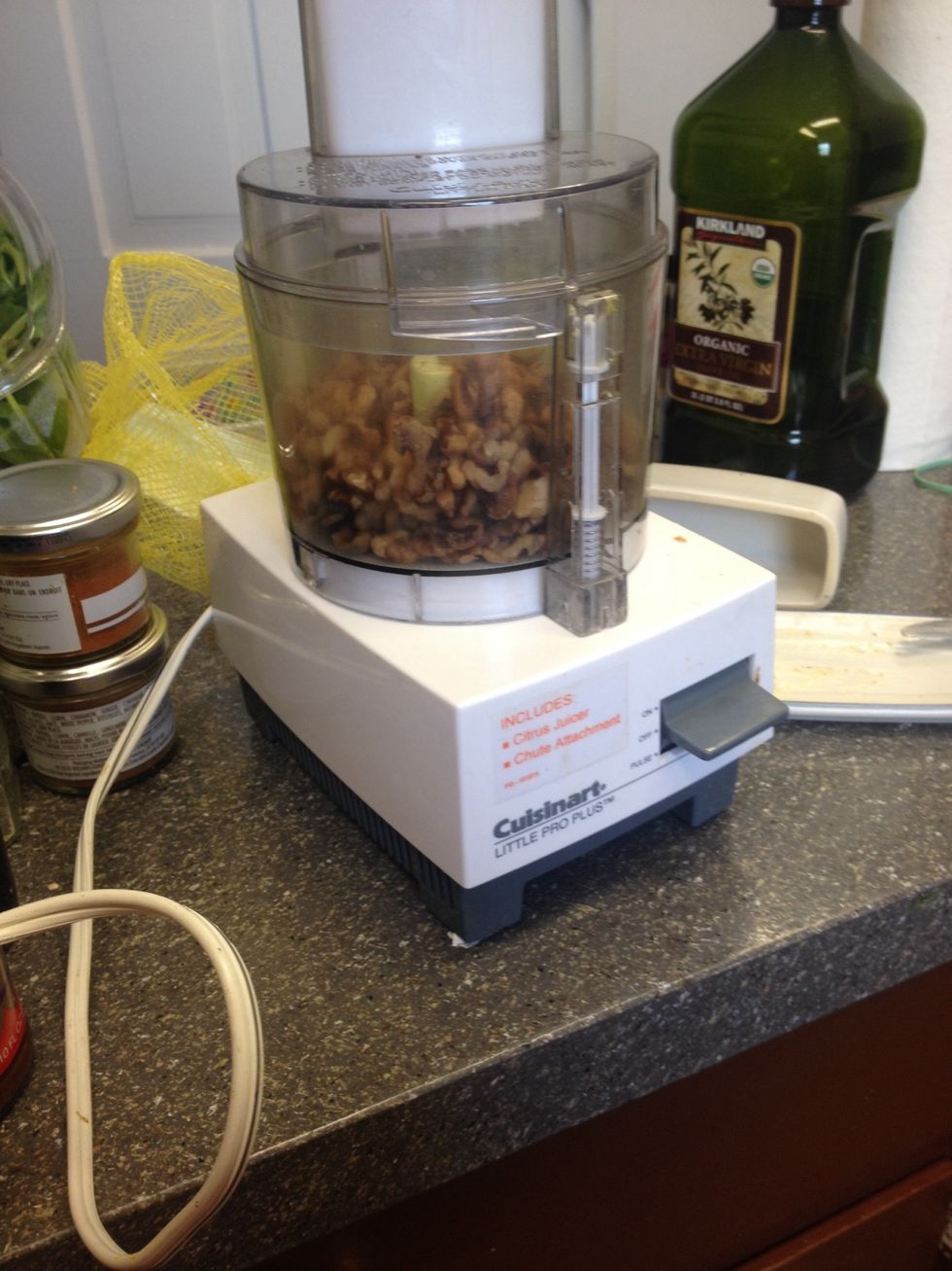 Chop nuts coarsely in the food processor. Then place in a large mixing bowl.
