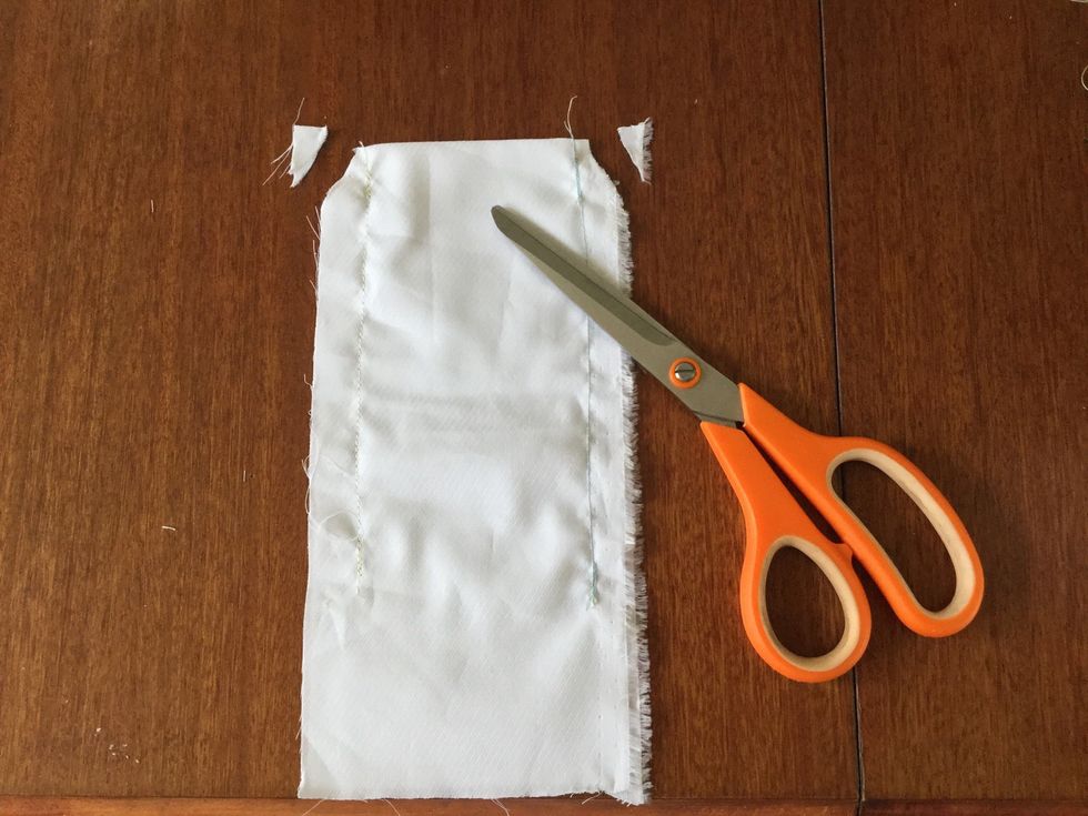 Chop off the corners of the case. This is because it reduces the bulk when turned the right way out and it looks better. Do his on both bits of material.