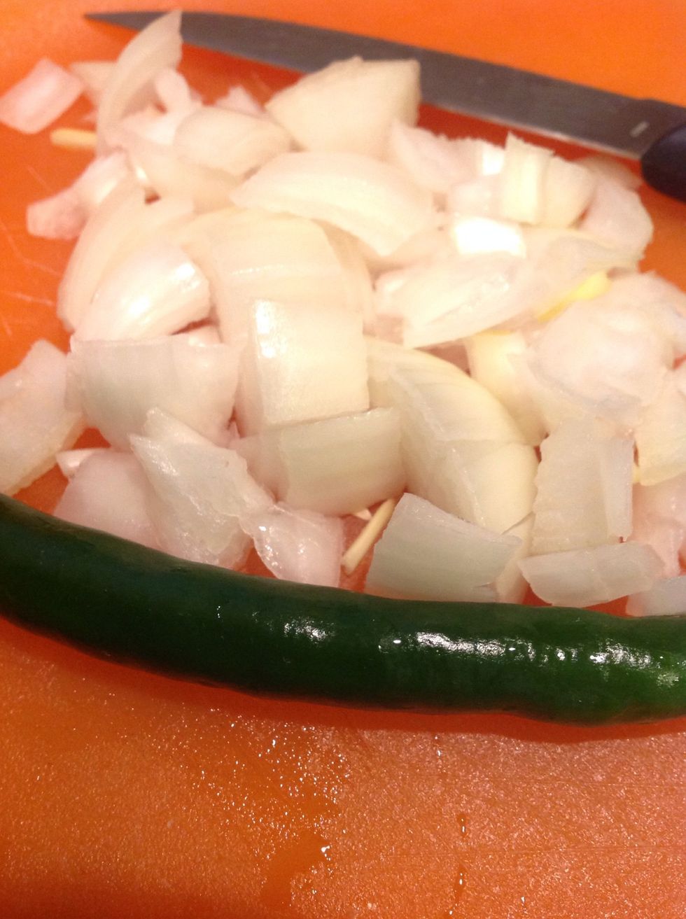 Chop onions and a green chilly.