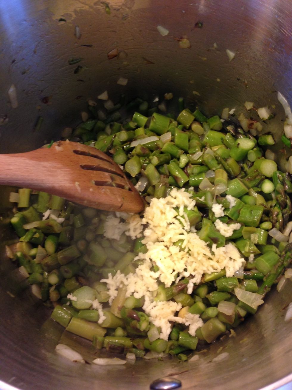 Chop or press the garlic, I love garlic so I always use a lot. Toss it in and give it a stir. As we stir between each step you are keeping the bottom of the ingredients from burning.
