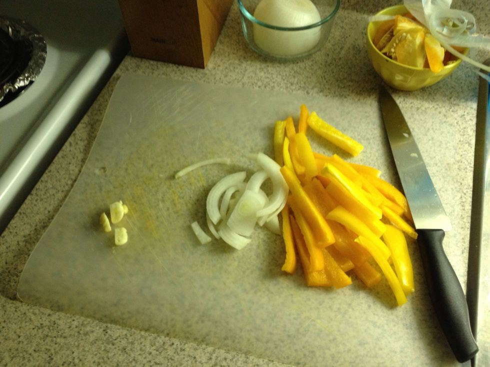 Chop peppers and onion in to sizeable strips. I did not use all the onion only use a little. Chop garlic into bits