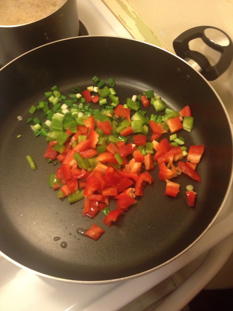 Chop red and bell peppers and add all to pan
