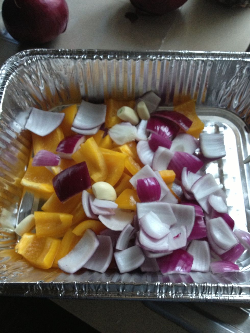 Chop red onions, bell peppers, unskin garlic