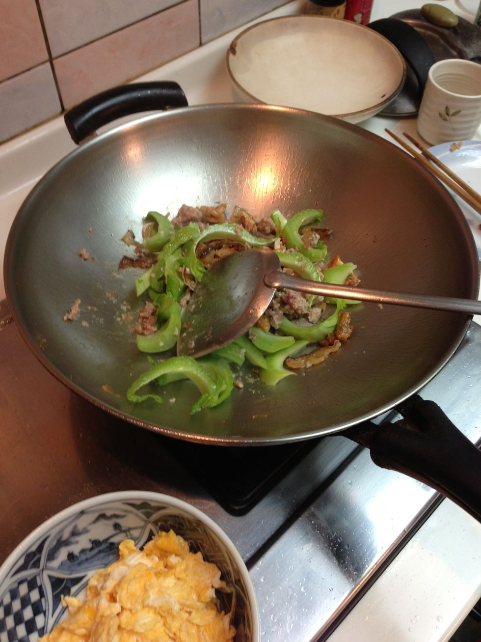 Chop roots of mustard greens thinly and add
