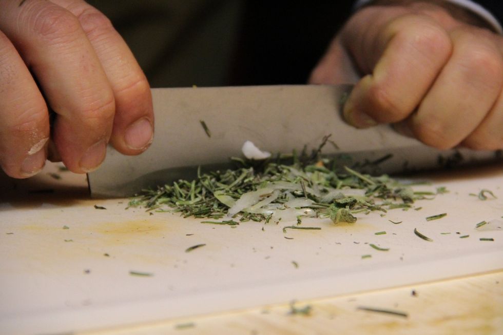Chop rosemary and sage leaves