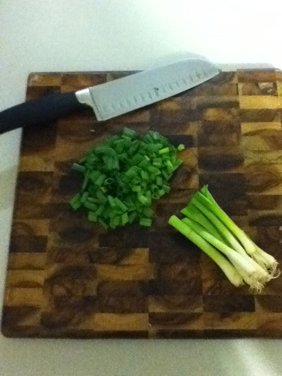Chop some green onions. You want the green tips off one whole bunch. Put 'em in a big serving bowl and set aside.