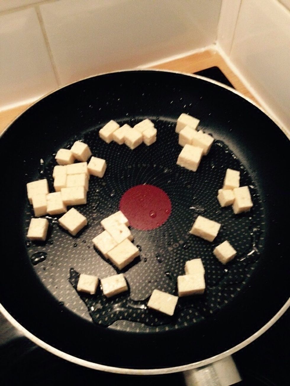 Chop some tofu into cubes and put it in a pan with a bit of sunflower seeds oil.
