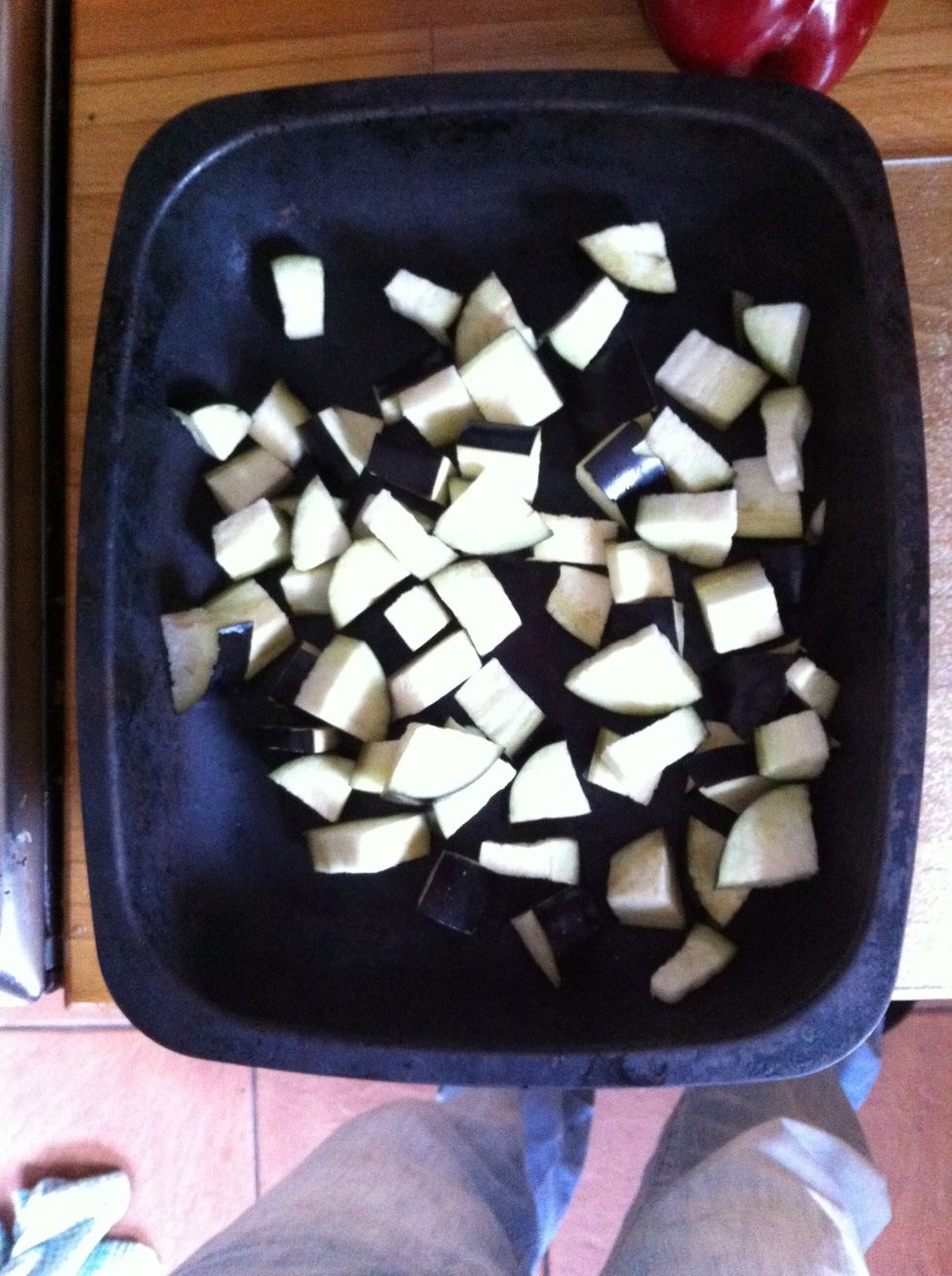 Chop the aubergine as small as you can and pop that in a different roasting tin.
