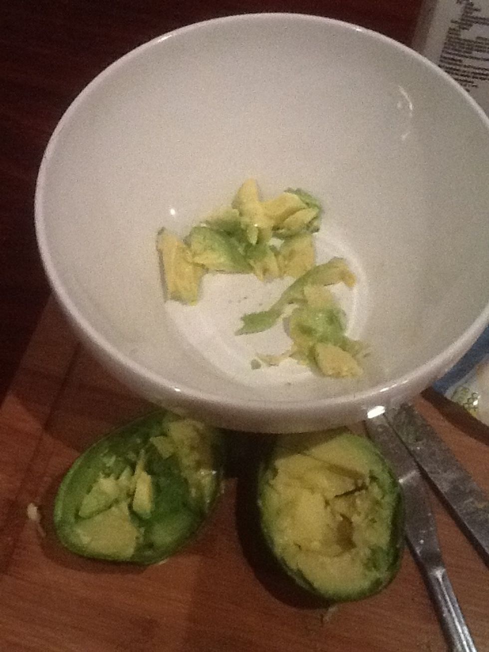 Chop the avocado into small bits and put in a bowl.