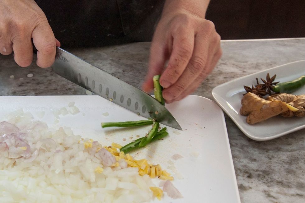 Chop the chilies.