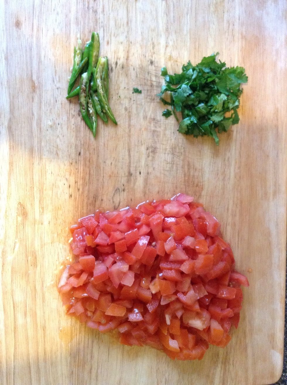 Chop the coriander and tomatoes and slice the green chillies and keep it aside.