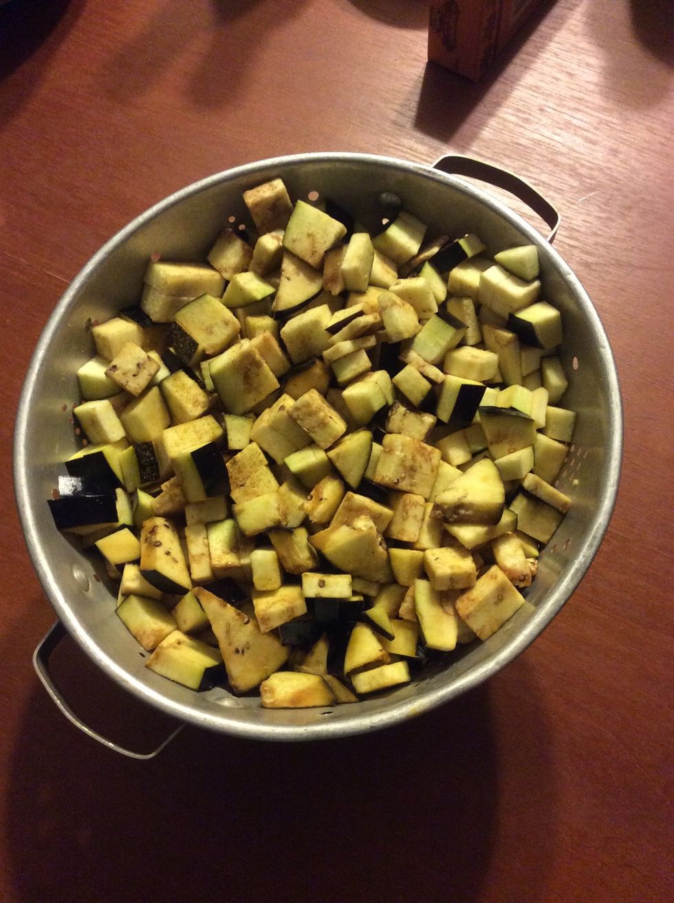 Chop the eggplants into rough 2cm chunks. Place in a colander, sprinkle with sea salt to draw out the moisture.