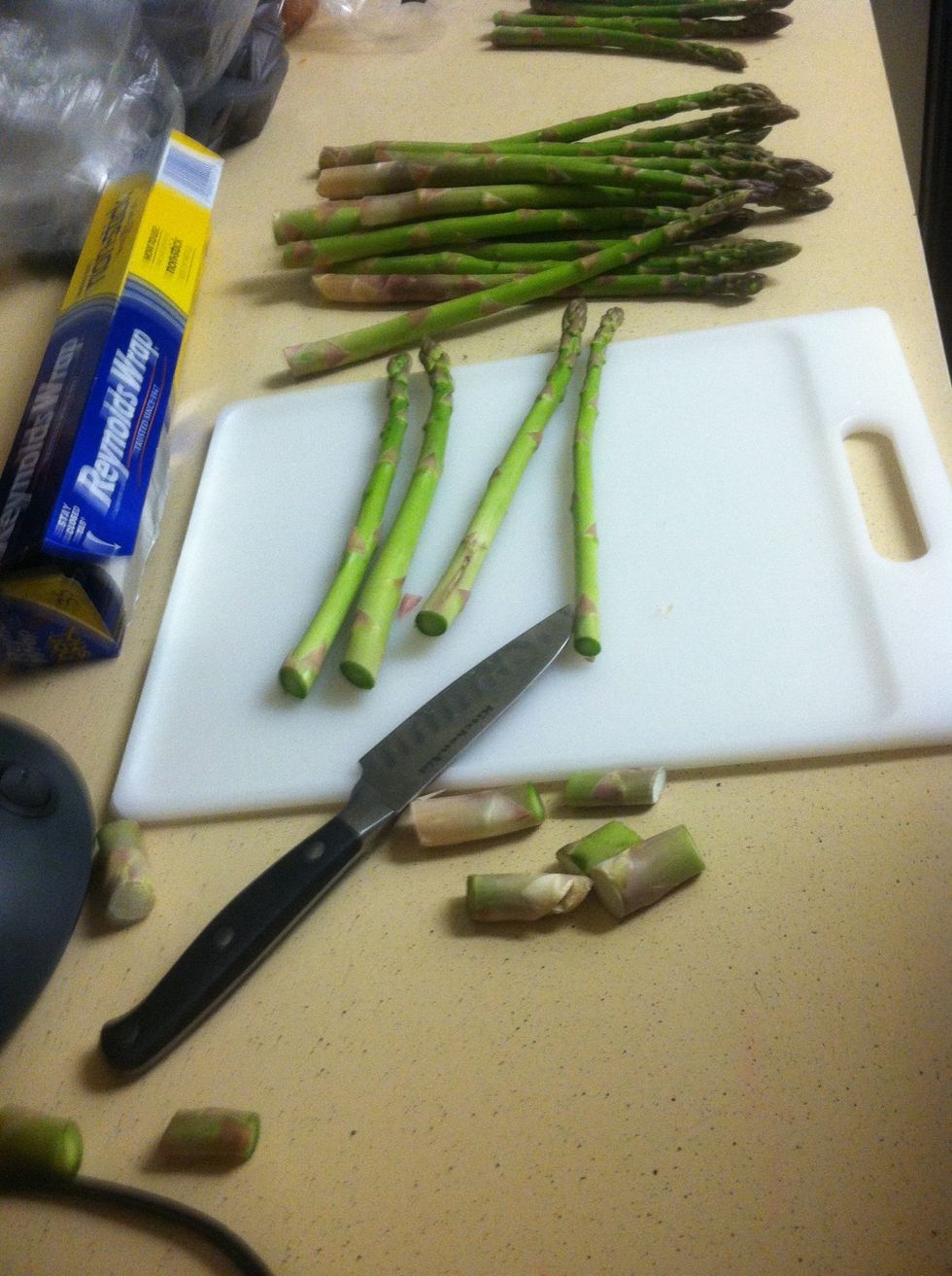 Chop the ends off the fresh asparagus.