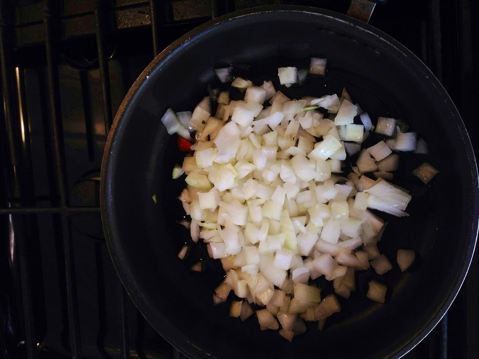 Chop the garlic and onion and put into a frying pan drizzled with olive oil and on medium/high heat. Cook until onion is translucent.