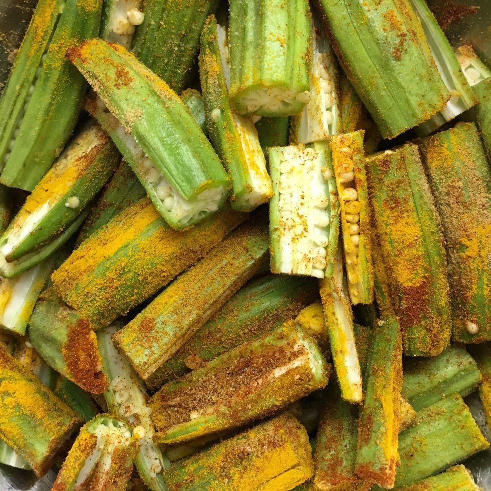 Chop the okra into quarters and season with ground turmeric, paprika, ground cumin, ground coriander and salt.