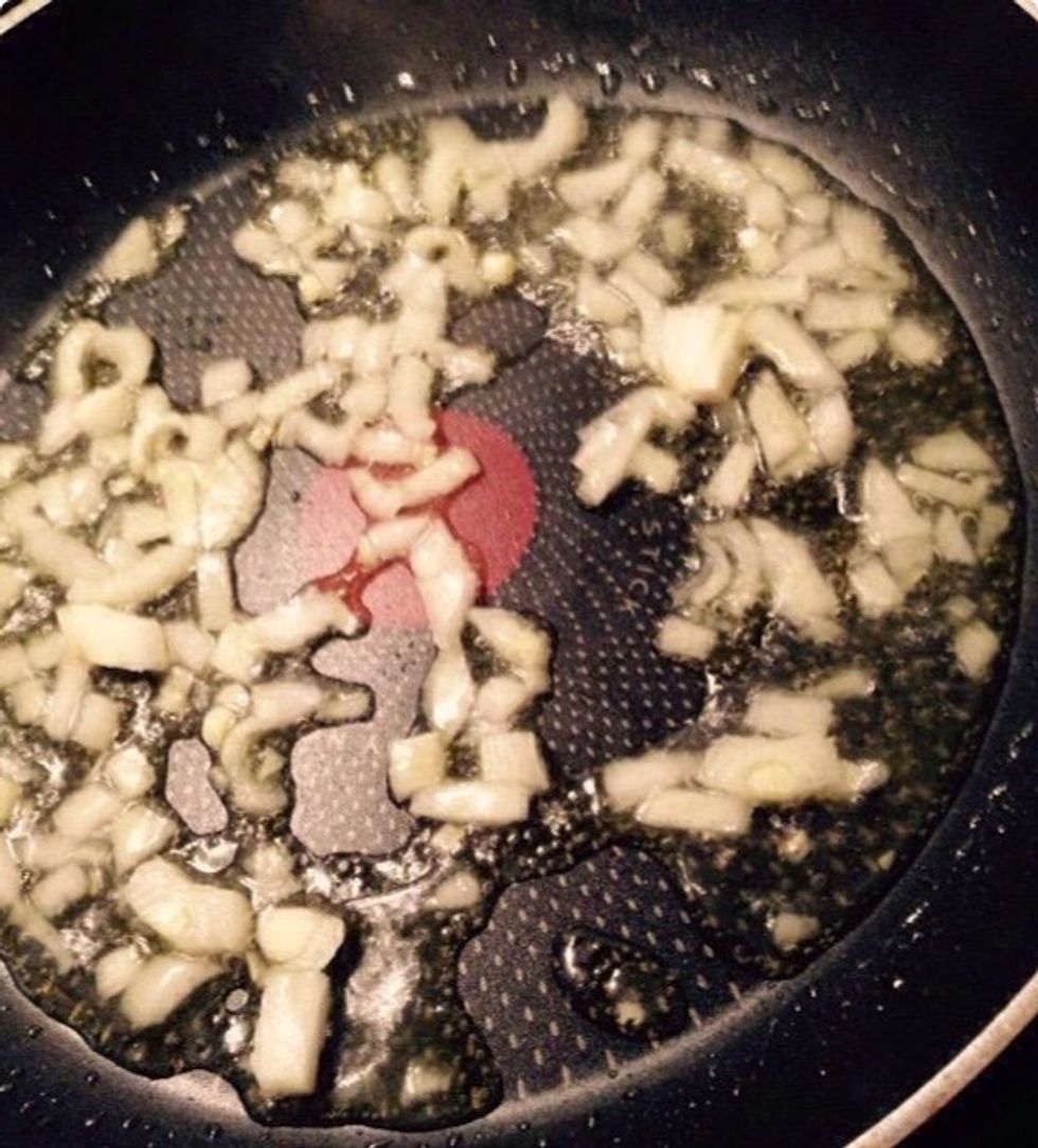 Chop the onion and add it to a pan with some olive oil and a splash of water.
