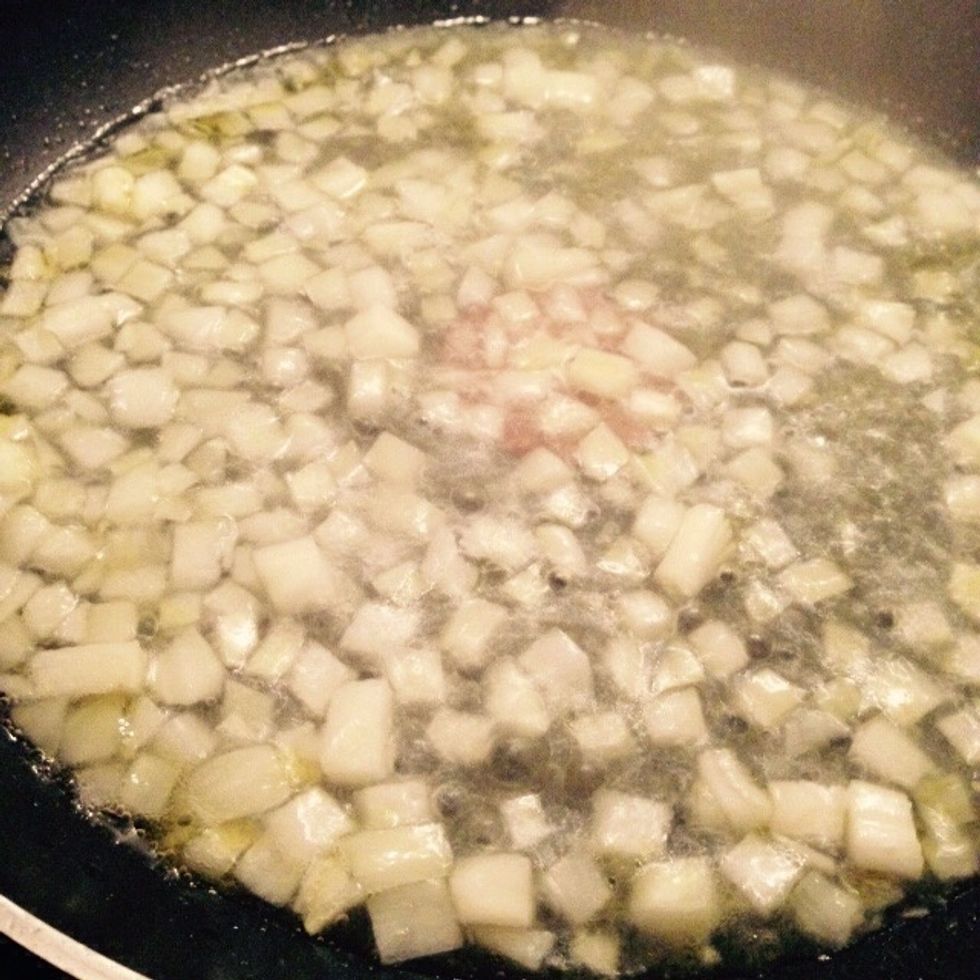Chop the onion and add it to a pan with some olive oil and a splash of water