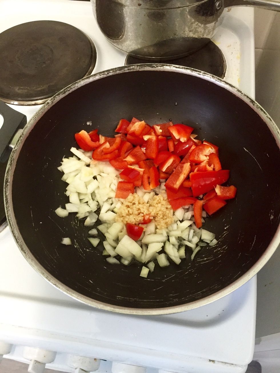 Chop the onion and pepper, and add it to the pan with garlic. Cook for a few minutes