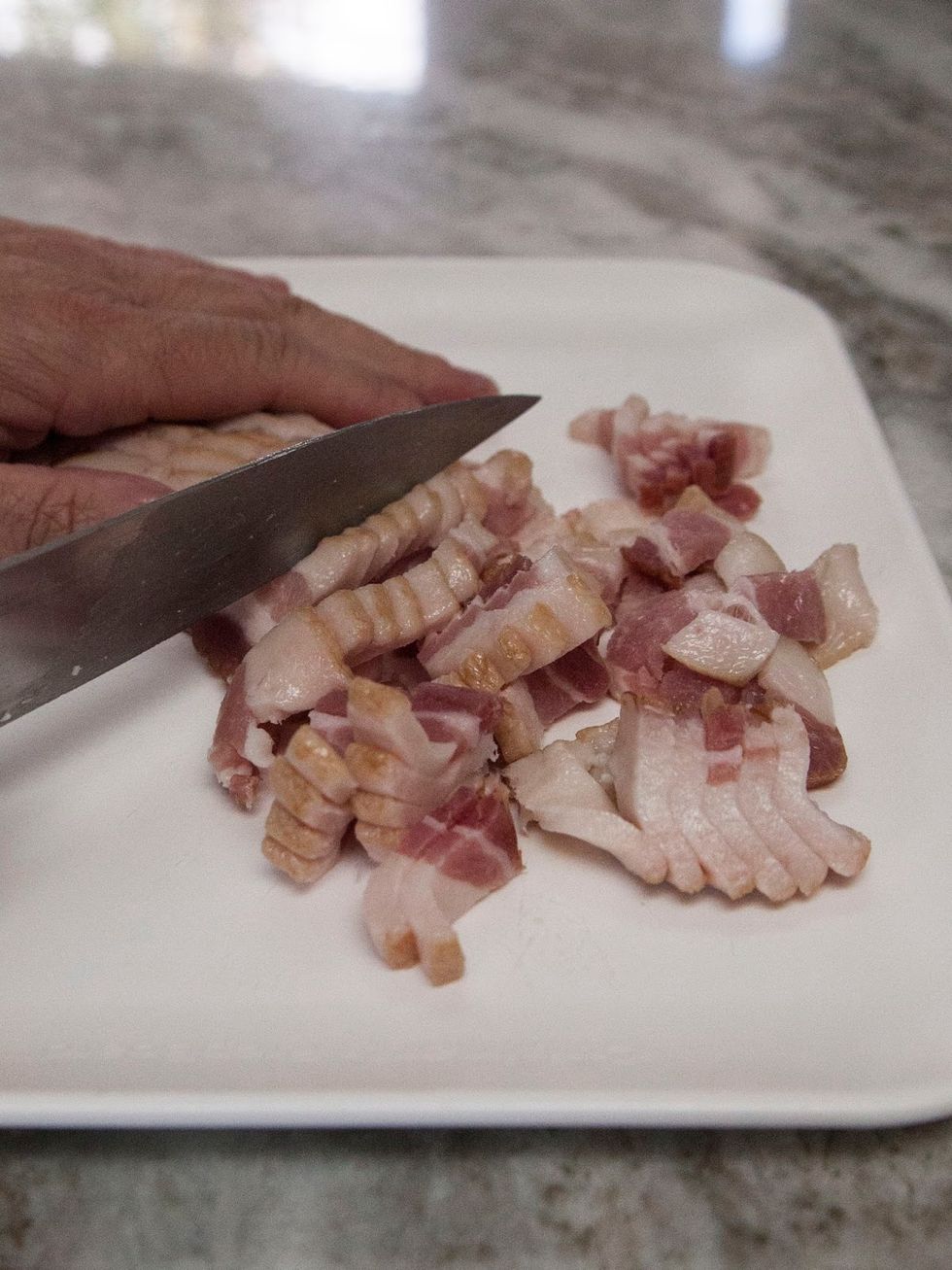 Chop the onion and set it aside. Chop your bacon into small pieces.