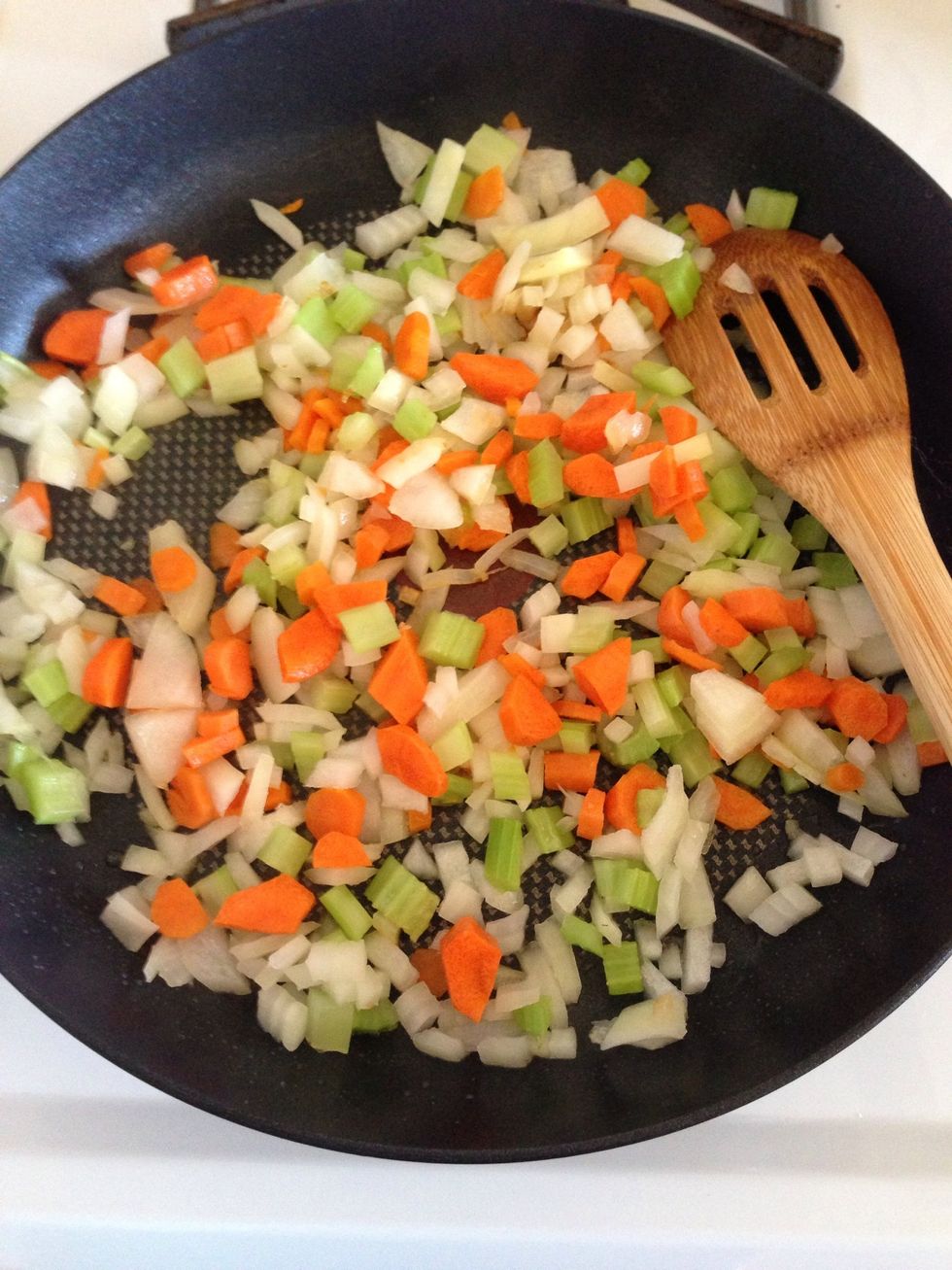 Chop the onion, celery, and carrots. In a pan, heat 2 tbs of oil and add your veggies. Cook until onion is translucent.