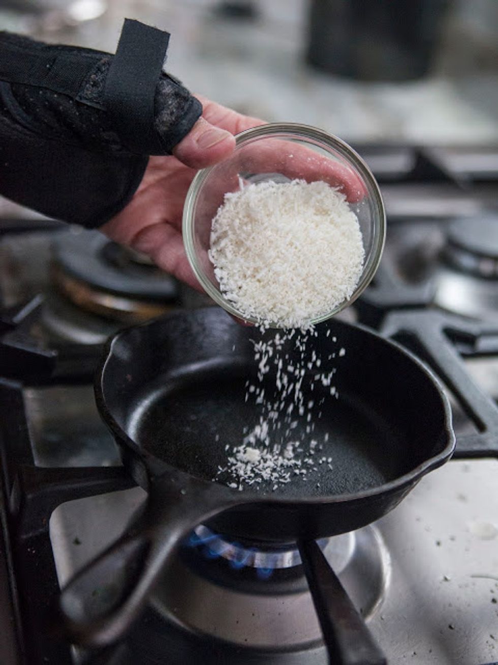 Chop the onion finely and set it aside. In a small skillet dry roast the dried coconut until it's fragrant and toasty....pardon the hand brace, I fell.