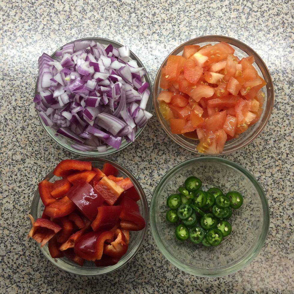 Chop the onion, tomato, bell pepper and serrano chili as shown.