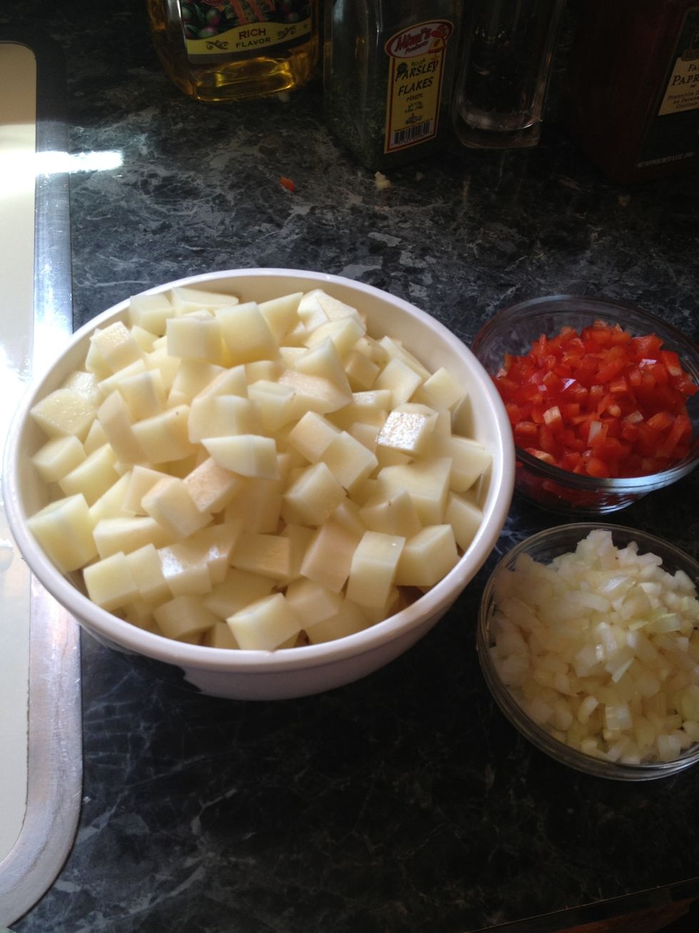 Chop the potatoes. Dice the onions and peppers set aside.