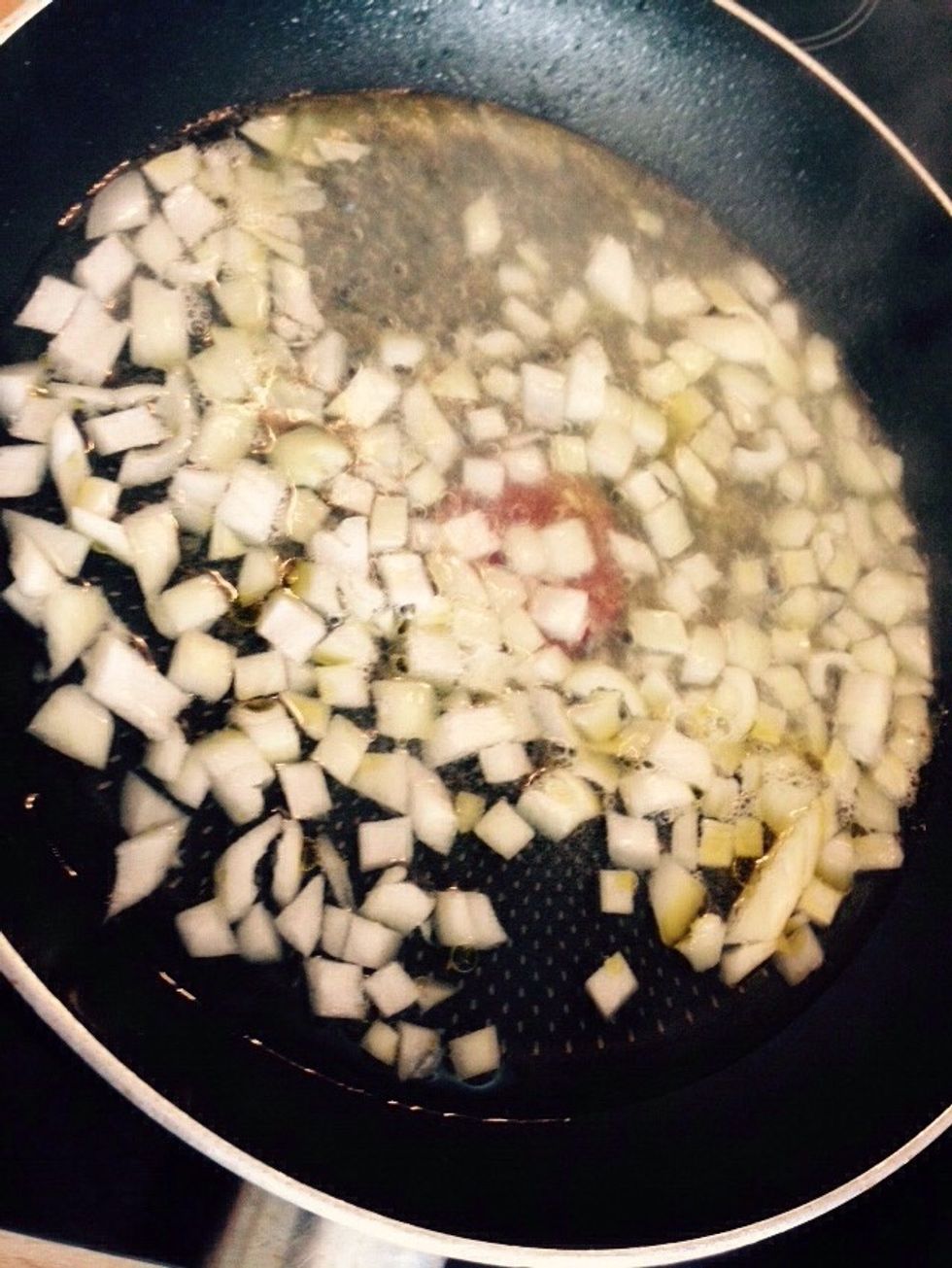 Chop the remaining 1/2 of the onion and add it to a pan with some olive oil and a splash of water