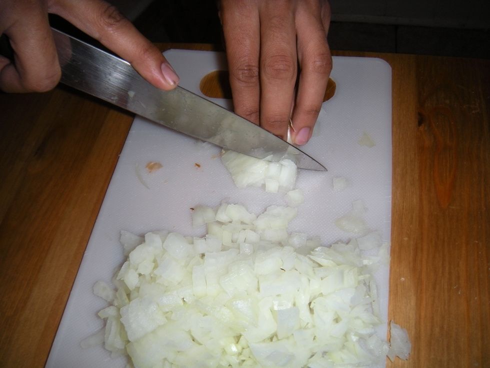 Chop the remaining onion perpendicularly to your previous cuts. Cut as close to the root as possible. Discard the root. This will decrease waste to a minimum.