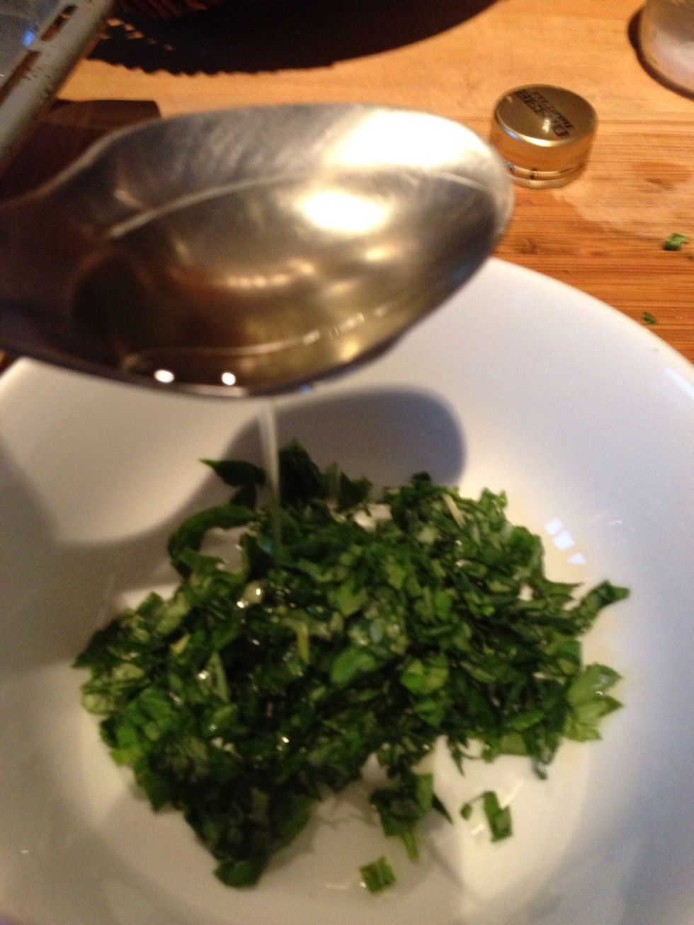 Chop the rest of the basil and mix it with the rest of the lemon juice, six tablespoons olive oil and two table spoons water to get a dressing. Taste with salt and pepper.