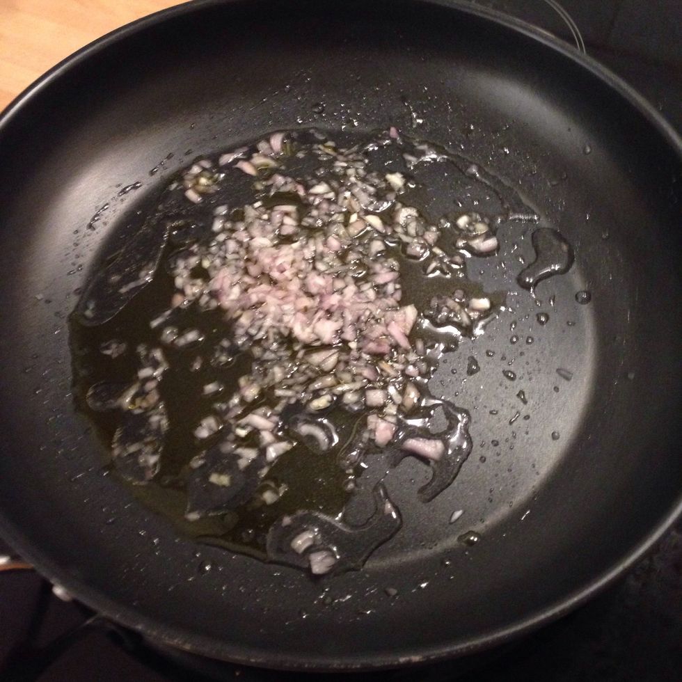 Chop the shallots and place them in a pan with some oil and a splash of water