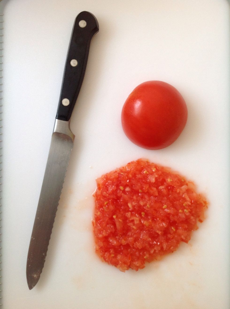 Chop the tomato up as finely as possible. A sharp knife is best.