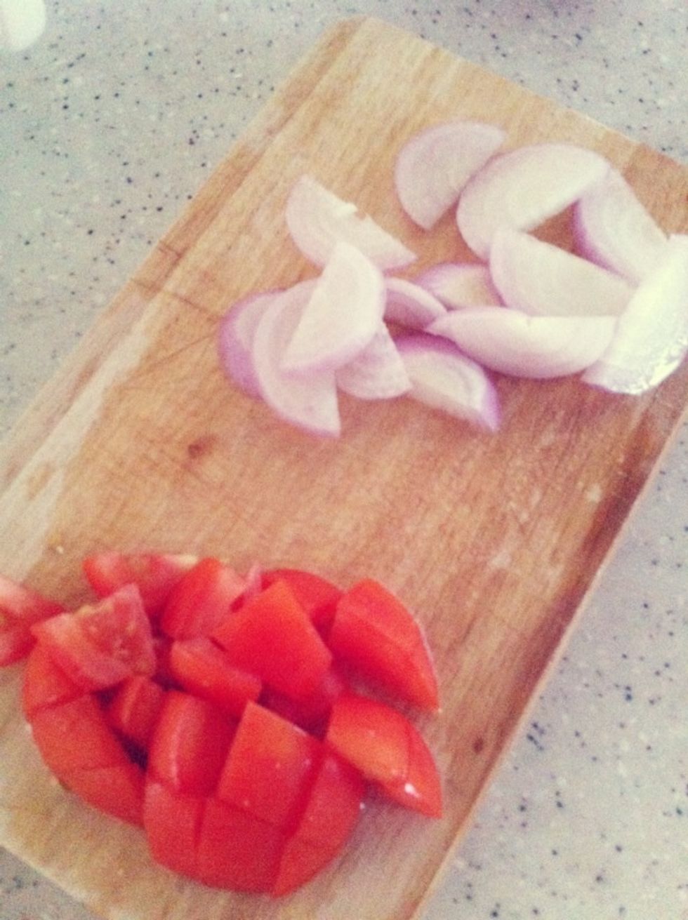 Chop tomato & onion into cubes & slices.