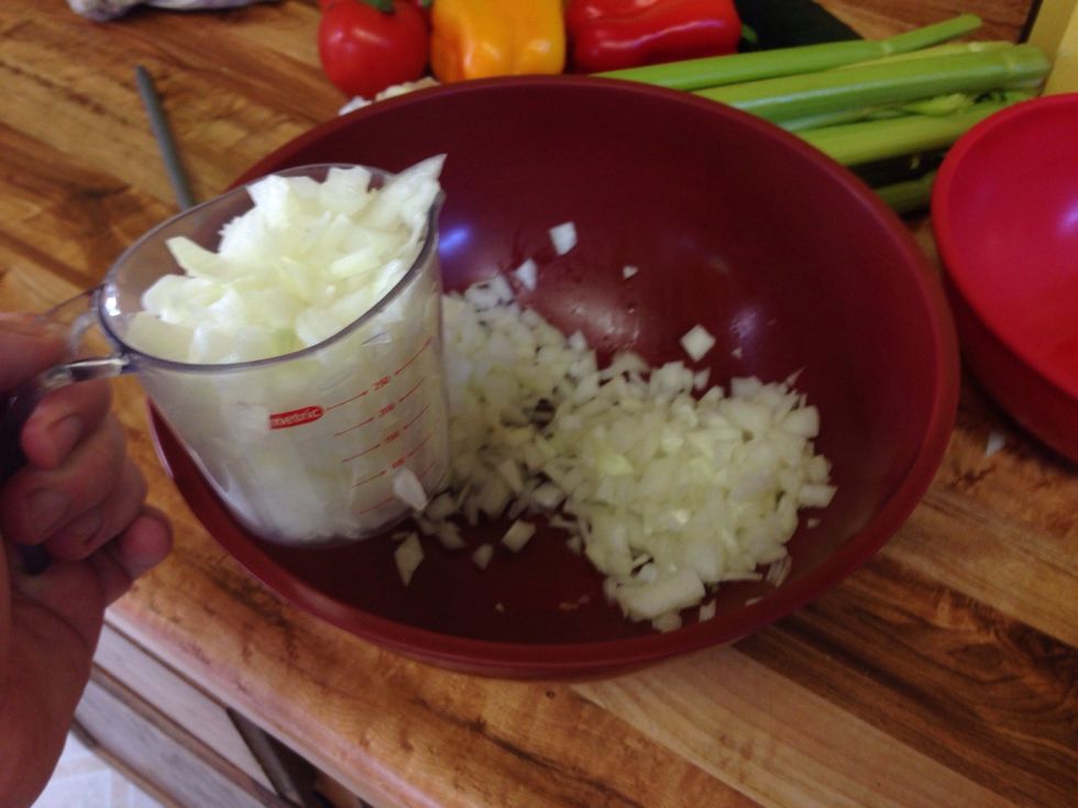 Chop up a large whole union into small fine bits. Measure how much onion you have after because you want half that amount of carrots and celery, each.