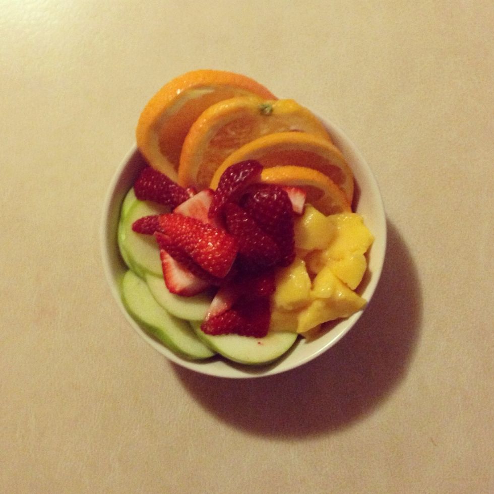 Chop up all the fruit, slice the strawberries and cut mangoes into chunks. Apples and oranges look best as circles