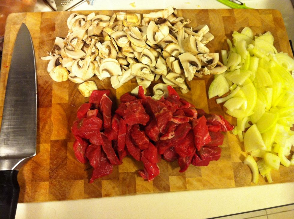 Chop up beef, mushrooms & onions into bite sized pieces. Dice potatoes and place in pot of water and bring to boil.