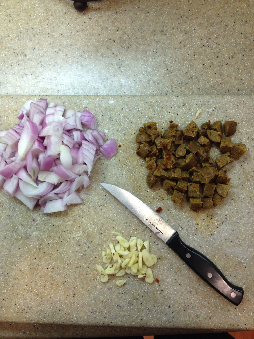 Chop up onion, garlic, and sausage.